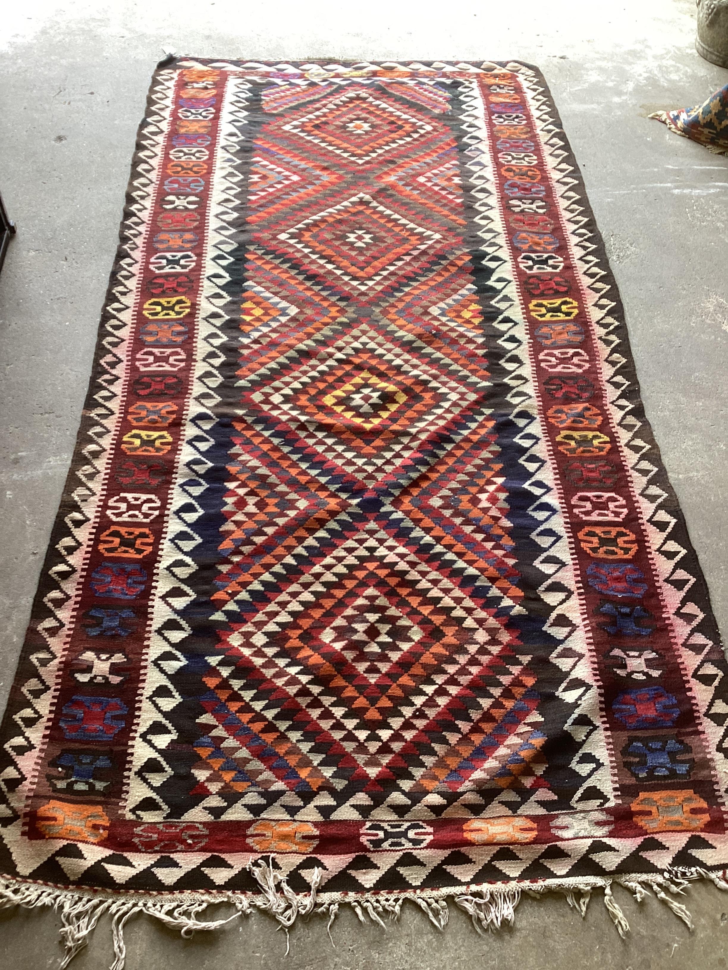 A Kelim polychrome flat weave carpet, 288 x 138cm